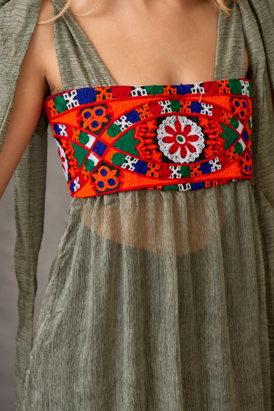 Close-up of colourful hand embroidery on olive chiffon boho dress - Zoe London Wearable Art Collection
