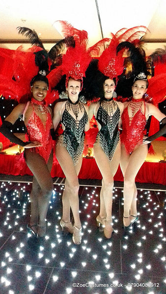 Black and red showgirl outfits with matching headdresses for live events